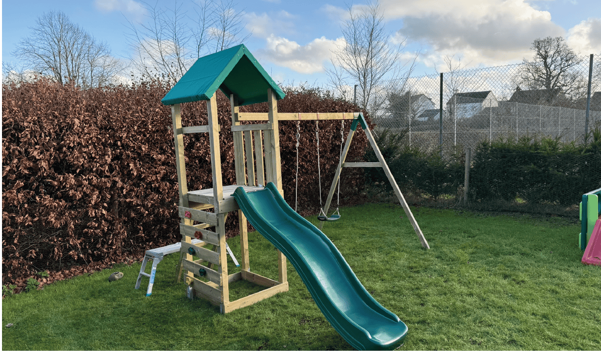 a kids climbing tower with swings